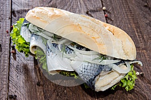 Herring Filet on a baguette (against wood)