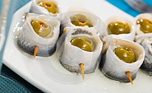 Herring rolls with stuffed olives