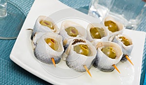 Herring rolls with stuffed olives