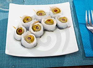 Herring rolls with stuffed olives