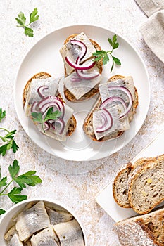 Herring sandwich. Open sandwiches with whole grain bread, herring and onion. Top view