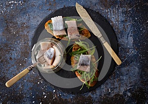 Herring sandwich traditional Danish smorrebrod on cutting boar