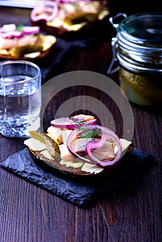 Herring sandwich with vodka glass