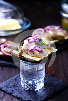 Herring sandwich with vodka glass