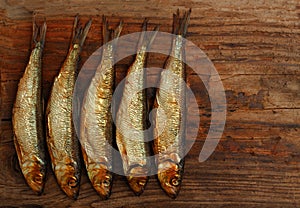 Herring sprat fish smoked wooden table