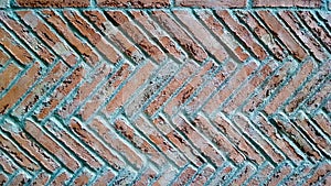 Herringbone brick pattern wall. Cement pointing