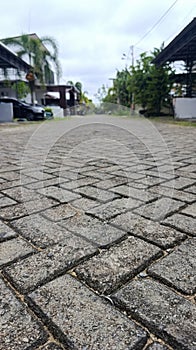 Herringbone pattern made from concrete paving blocks creating a textured urban surface.
