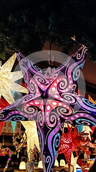 Herrnhut stars, bright colorful decoration at the Christmas market, star shaped lamp