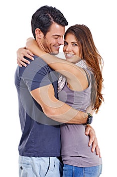 Hes a catch. Studio shot of a loving young couple embracing isolated on white.