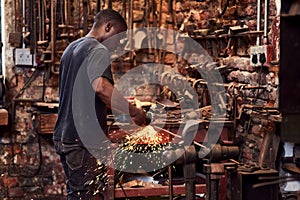 Hes caught in the heat of the moment. a handsome young metal worker using a blowtorch while working inside a welding