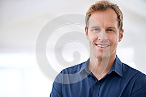 Hes a chilled guy. Cropped portrait of a handsome man smiling at home.