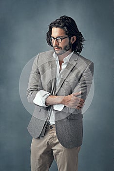 Hes a classy gentleman. Cropped studio shot of a handsome and stylish young man against a grey background.