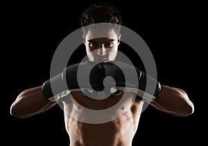 Hes dedicated to the sport of boxing. Portrait of a young male boxer in a fighting stance.