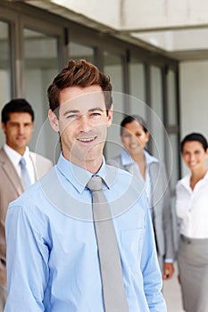 Hes earned the respect of his colleagues - Business Leader. A young business leader standing in front of his team