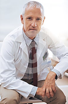 Hes a focused medical professional. Portrait of a serious-looking male doctor sitting in his office.