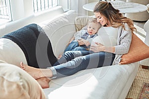 Hes going to be an amazing big brother. a pregnant woman bonding with her toddler son at home.