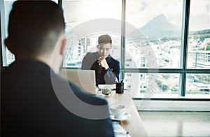 Hes going to disrupt the industry with those plans. two young businessmen working together at a desk in a modern office.