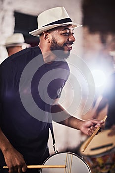 Hes got all the beats. Shot of a young musician performing with his band.