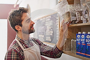 Hes got every flavor. a male barista working in a coffee shop.