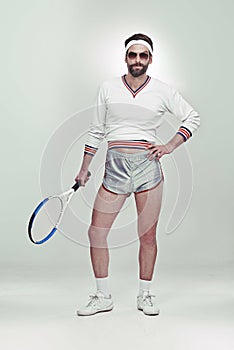 Hes got game. Portrait of a young retro tennis player in the studio.