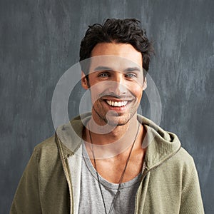 Hes got the perfect smile. Portrait of a handsome young man smiling happily.