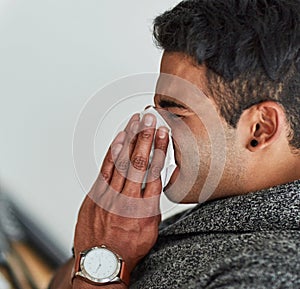 Hes got the sniffles. a young man suffering with allergies. photo