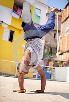 Hes got talent. Low angle shot of a young male breakdancer in an urban setting.