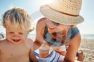 Hes happiest when were at the beach. a single mother spending the day at the beach with her little boy.