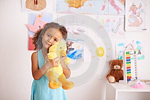 Hes my best friend. Portrait of an adorable little girl holding her teddybear.