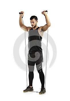 Hes owning this workout. Studio shot of a young man working out with a resistance band against a white background.