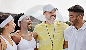 Hes a proud coach. Cropped shot of three young tennis players and their coach standing outside on the court.