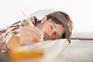 Hes a skilled carpenter. A handsome young carpenter measuring and marking wood.
