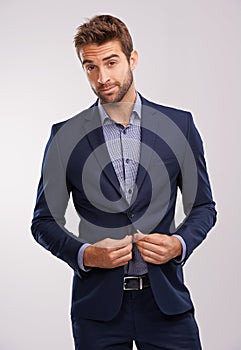 Hes a snappy dresser. Studio shot of a handsome well-dressed man against a gray background.