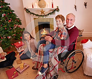 Hes so special to me. Portrait of a young boy sitting on his grandpas lap.