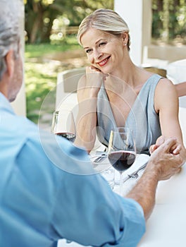 Hes still her dream guy. Happy mature couple toasting their love with two glasses of wine while outdoors.