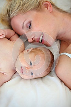 Hes such a cute little guy. High angle shot of a mother and her newborn child lying in bed.