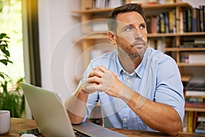 Hes always thinking of ways to achieve success. a young man working from home.