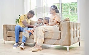 Hes so ticklish. Full length shot of a young couple bonding with their children at home and tickling them.