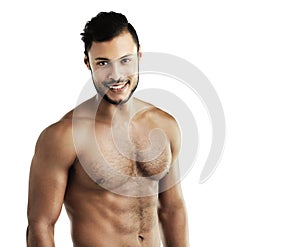 Hes in tiptop shape. Studio portrait of an athletic young man posing against a white background. photo