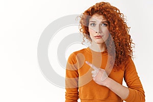 Hesitant worried cute redhead female friend with curly hairstyle doubting your choice, frowning and smirk concerned