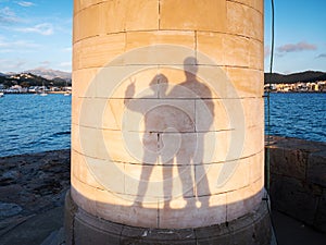 Heterosexual couple makes funy shadows on wall