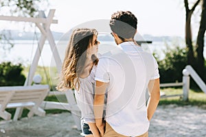 heterosexual couple standing at city beach