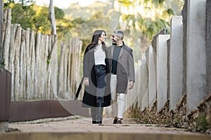 A heterosexual couple taking a walk on a path