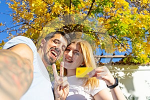 Heterosexual Happy couple celebrate and show the credit card with excited, looking at camera.