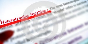 heterotrophic nutrition displayed on white paper with red colour underline text photo