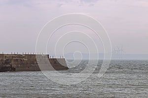 Heugh breakwater pier in stormy, cloudy weather seascape