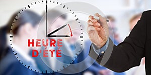 Heure d`ete, French Daylight Saving Time, Business man hand writ photo