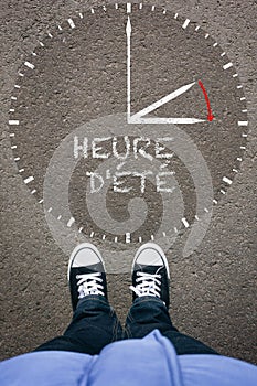 Heure d`ete, FrenchDaylight Saving Time on asphalt with two shoe photo