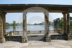 Hever castle garden's colonnade, patio at a lakeside in England