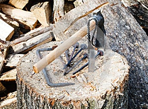 Hew axe and forged hardware on wooden block